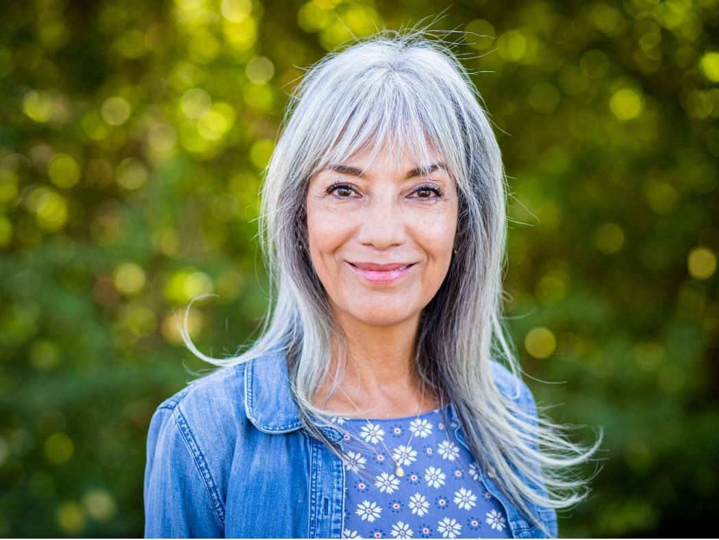 Middle age woman with grey hair beginning fulfilling retirement